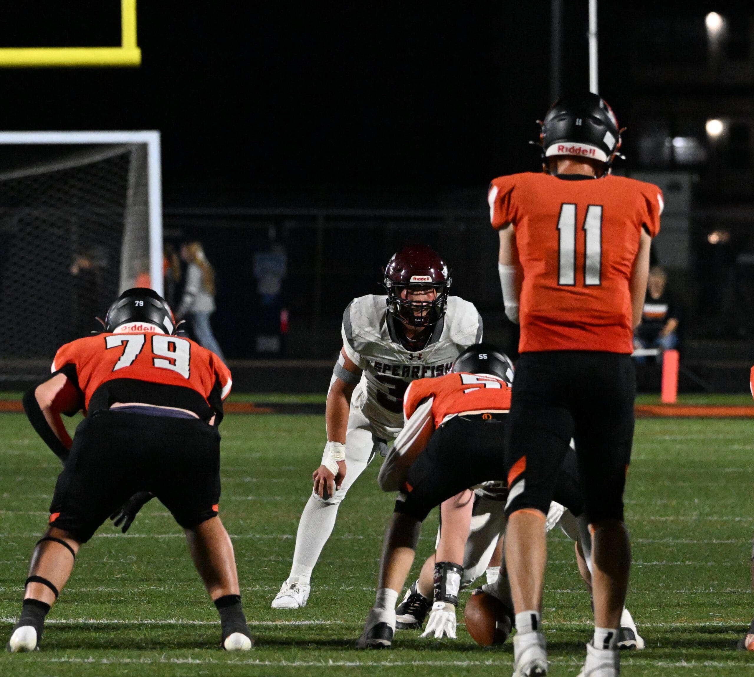 Spearfish Spartans linebacker Brock Lewis locks in on Huron Tigers quarterback Anderson Porisch during Friday night game.
