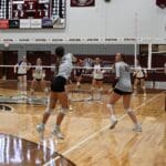 Kaitlyn Wheaton and Tabatha Zandstra of the Spearfish Spartans Volleyball Team return a ball against the Custer Wildcats in a home volleyball match.