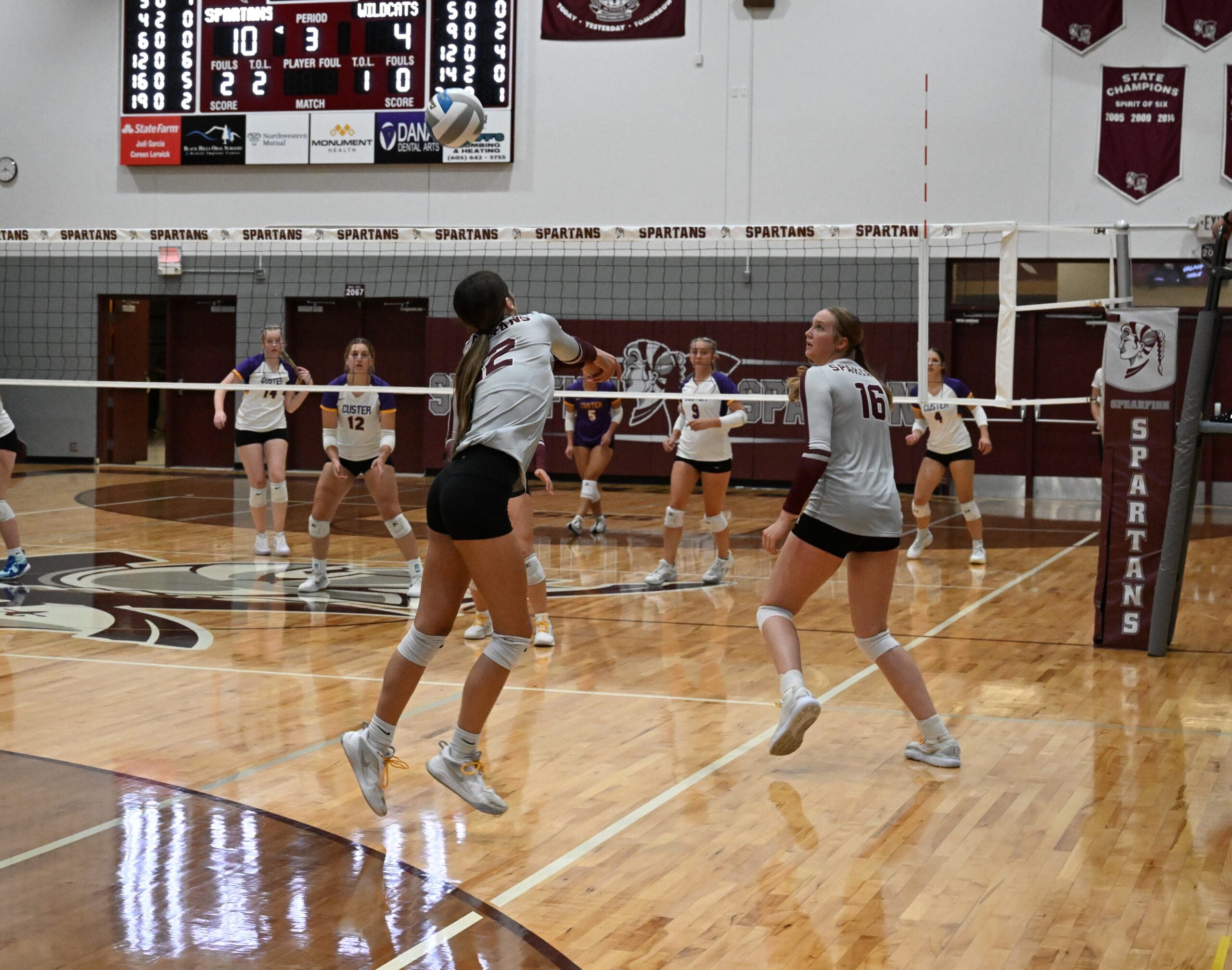 Kaitlyn Wheaton and Tabatha Zandstra of the Spearfish Spartans Volleyball Team return a ball against the Custer Wildcats in a home volleyball match.
