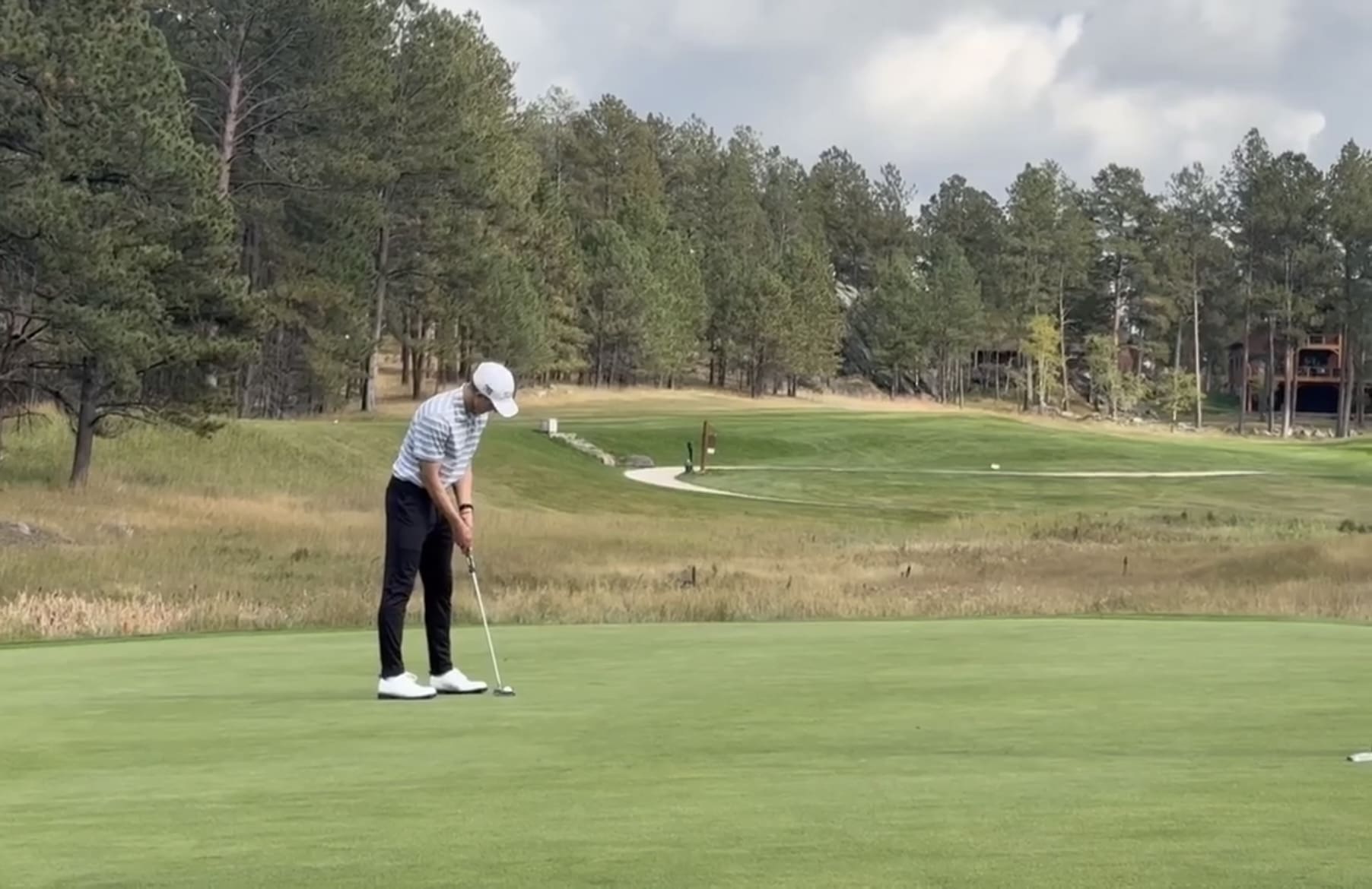 Bennett Kortan of the Spearfish Spartans lines up a birdie putt during the Black Hills Conference golf meet in Custer, SD.