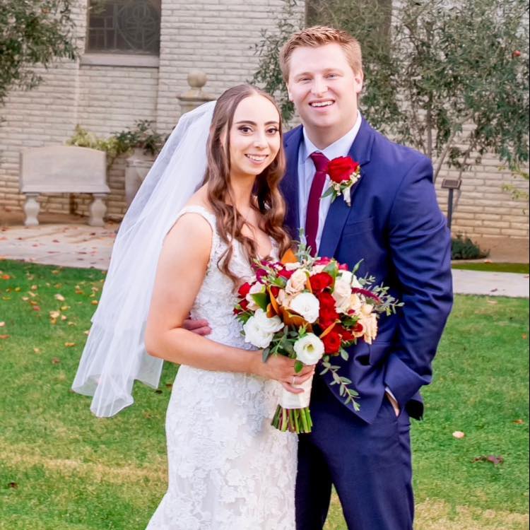 Colton Hall, the owner of Odrix Media poses with his wife Alyssa.