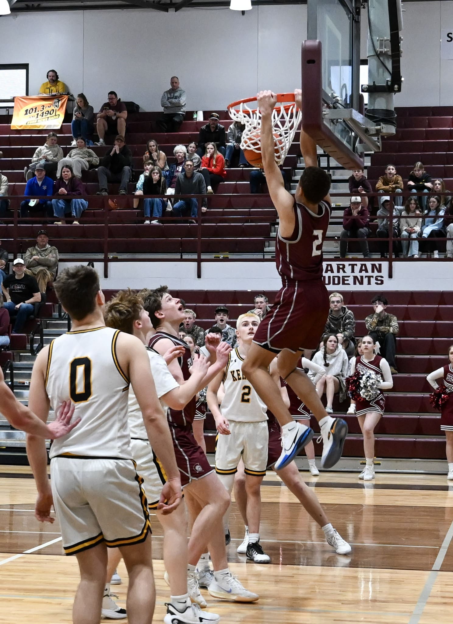 Spearfish's Kamren Davis blows past devenders in Spearfish Spartans vs. Mitchell Kernels Boys Basketball Game in Spearfish for dunk.