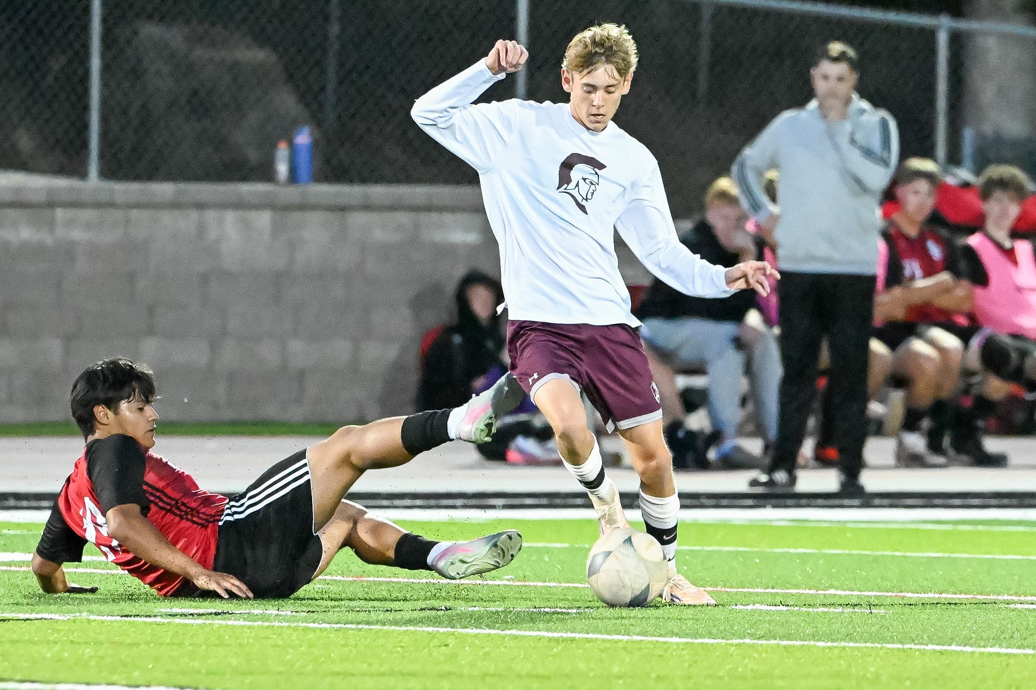 Brooks Meyer of the Spearfish Spartans Boys Soccer team dribbles past a Sturgis Scoopers defender in the Spartans matchup at Woodle Field in Sturgis, SD on Tuesday, September 15, 2026.