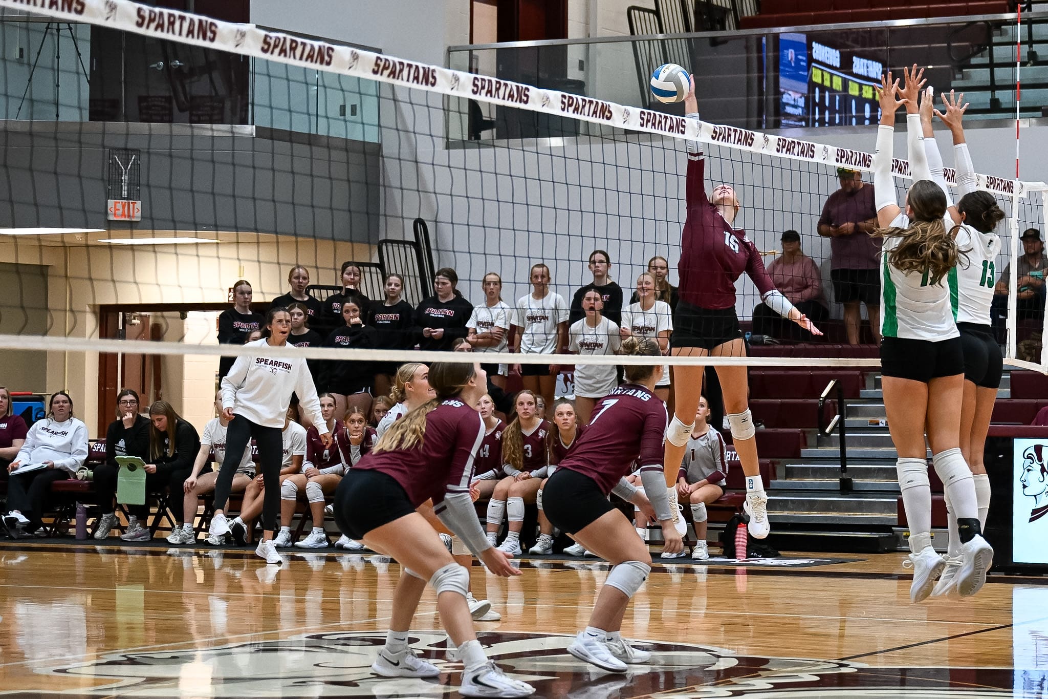 Spearfish Spartans volleyball player Julia Billington goes up at the net against two Pierre Governors blockers during a home match at Spearfish High School.