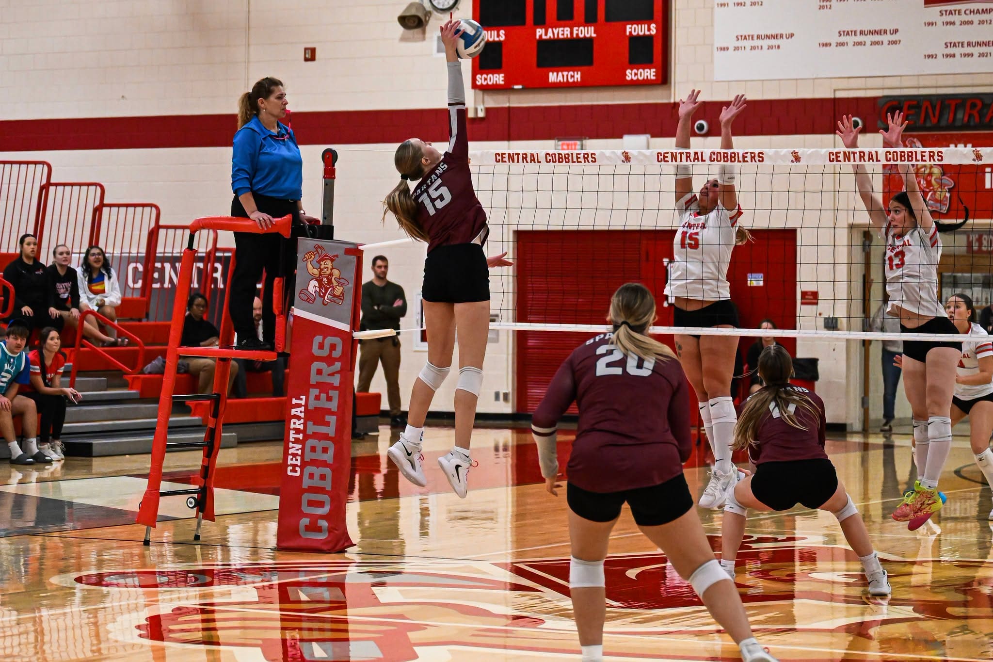 Spearfish’s Julia Billington (15) rises to hit a kill over two Rapid City Central blockers at Howard Naasz Gymnasium on Oct. 27, 2026.