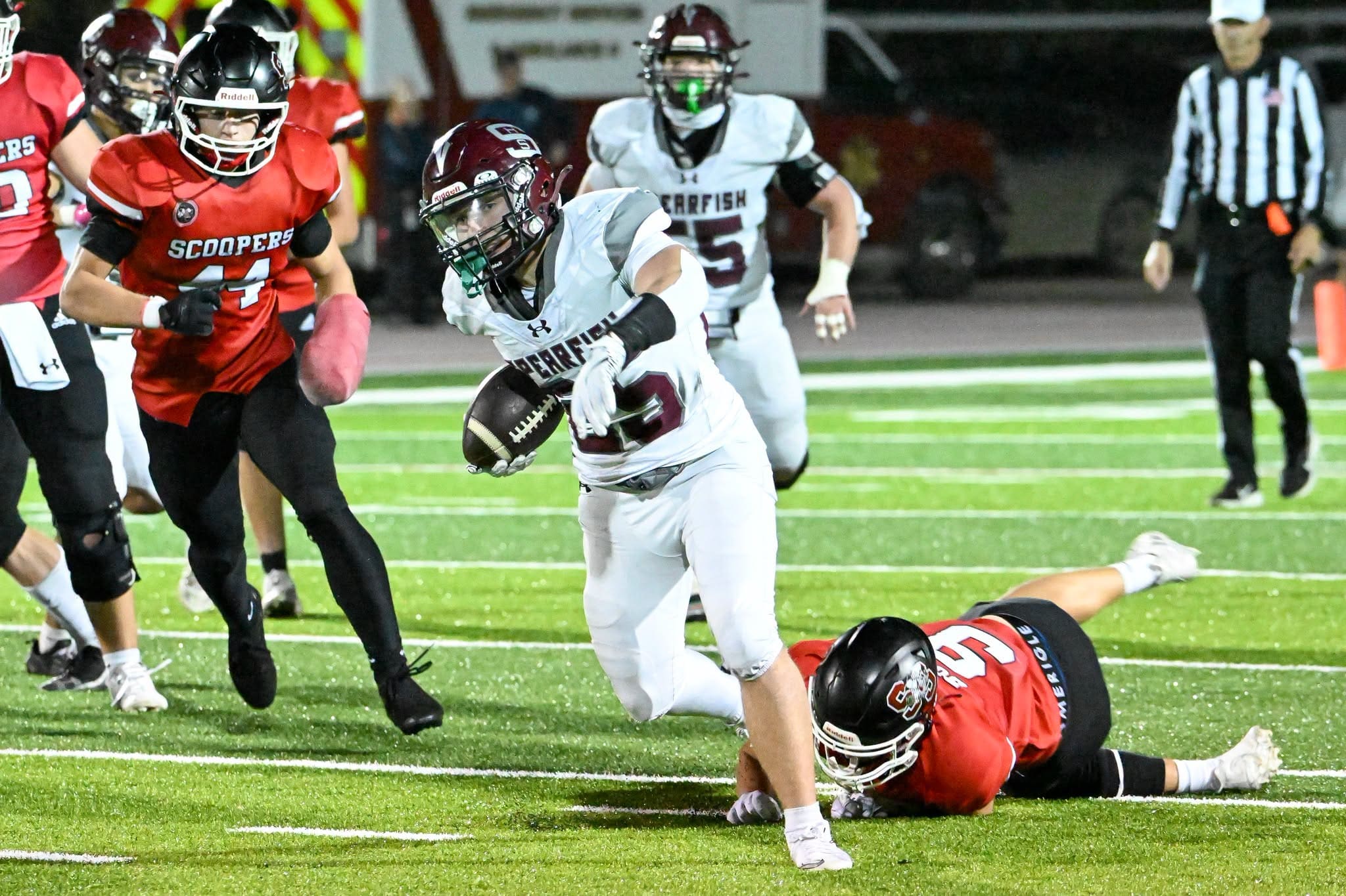 Spearfish Spartans running back Graham Hughes cuts upfield past a diving Sturgis Scoopers defender during Spearfish’s 41-20 loss at Woodle Field.