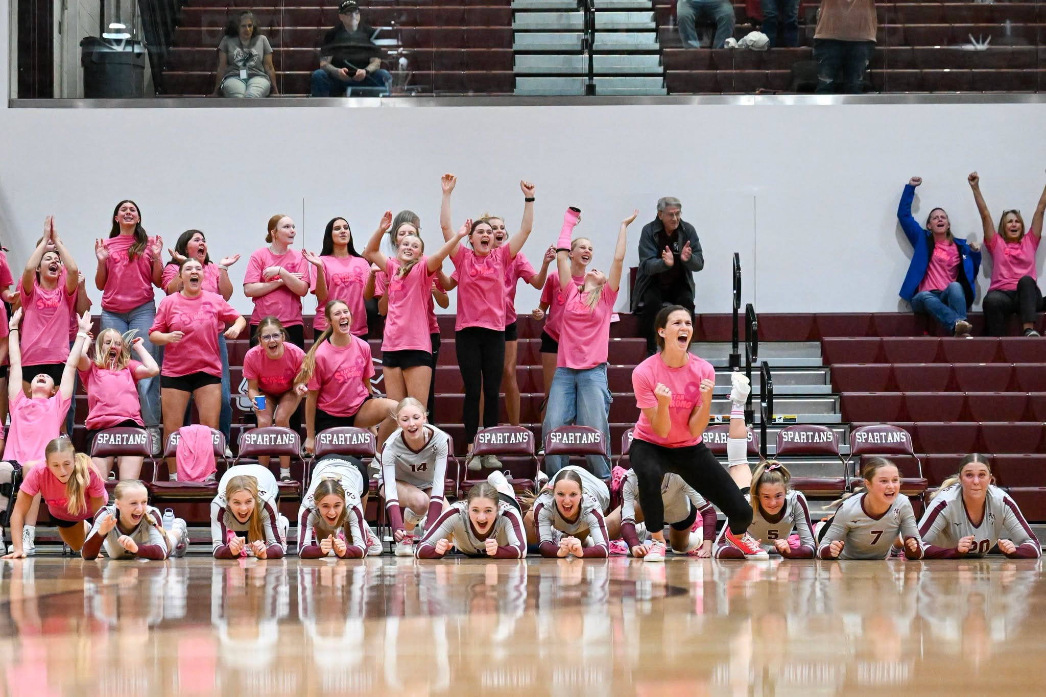 Spearfish Spartans volleyball players and teammates celebrate after a win over the Sturgis Scoopers on Oct. 6, 2026, at Spearfish High School.